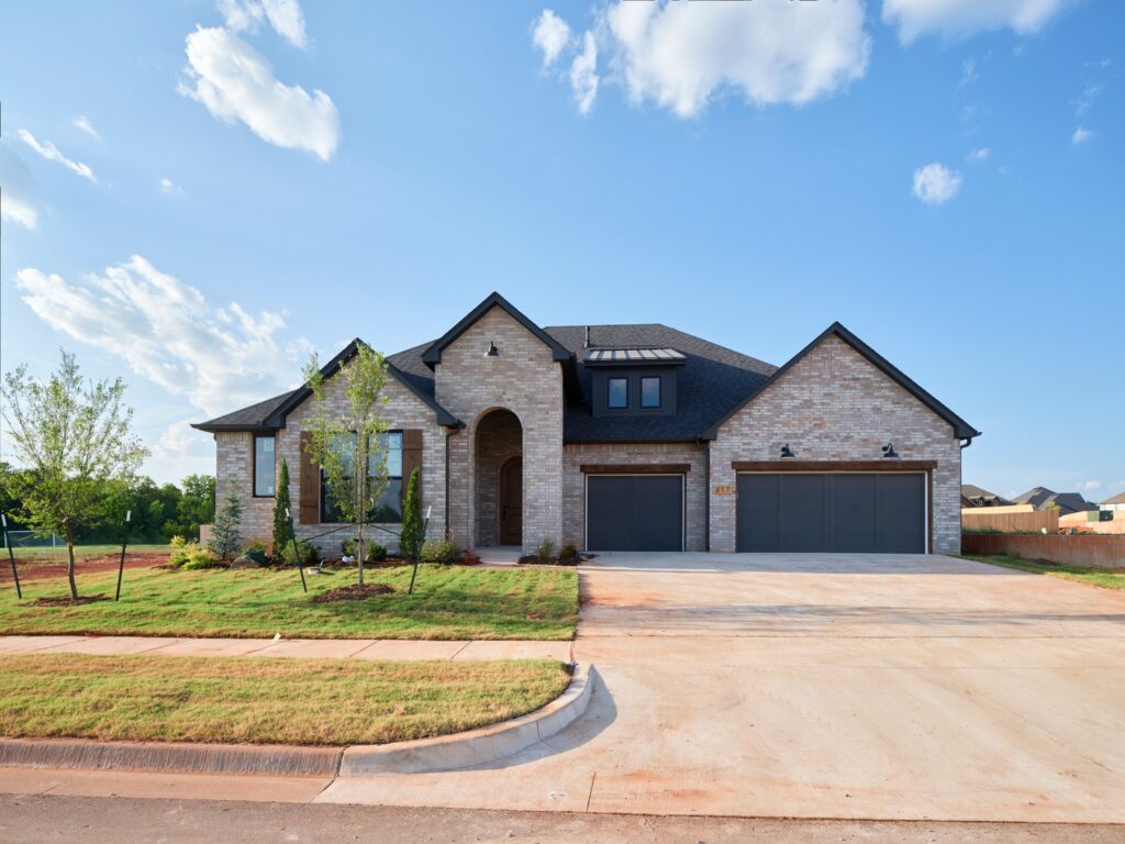 Modern brick house with a three-car garage, Maddie floor plan in the Oklahoma City metro area.