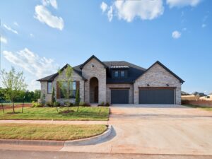 Modern brick house with a three-car garage, Maddie floor plan in the Oklahoma City metro area.