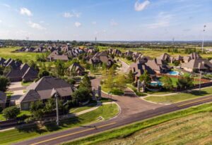 Aerial view of The Springs at Valencia, a spacious residential neighborhood filled with numerous houses in Oklahoma City.
