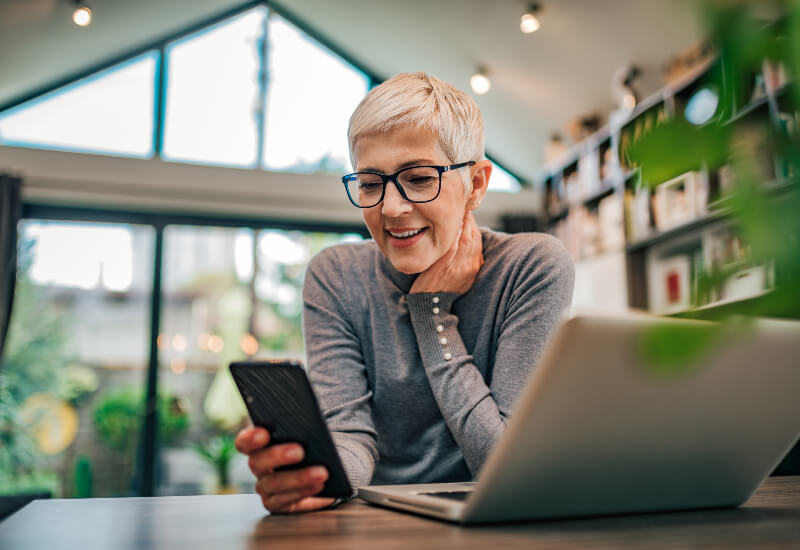 Women checking the Custom Homes & Spec Homes difference on the phone in the Oklahoma City metro area