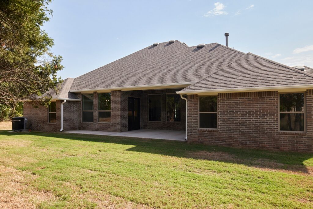 Backyard patio of a brick home with Preston side entry floor plan in the Oklahoma City metro area.