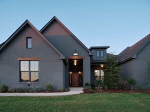 Contemporary gray brick home with peaked roofs & Hudson Floor Plan in the Oklahoma City metro area.