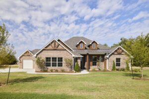 Lyla Plan brick home in Oklahoma City with gables, dormers, and spacious front yard