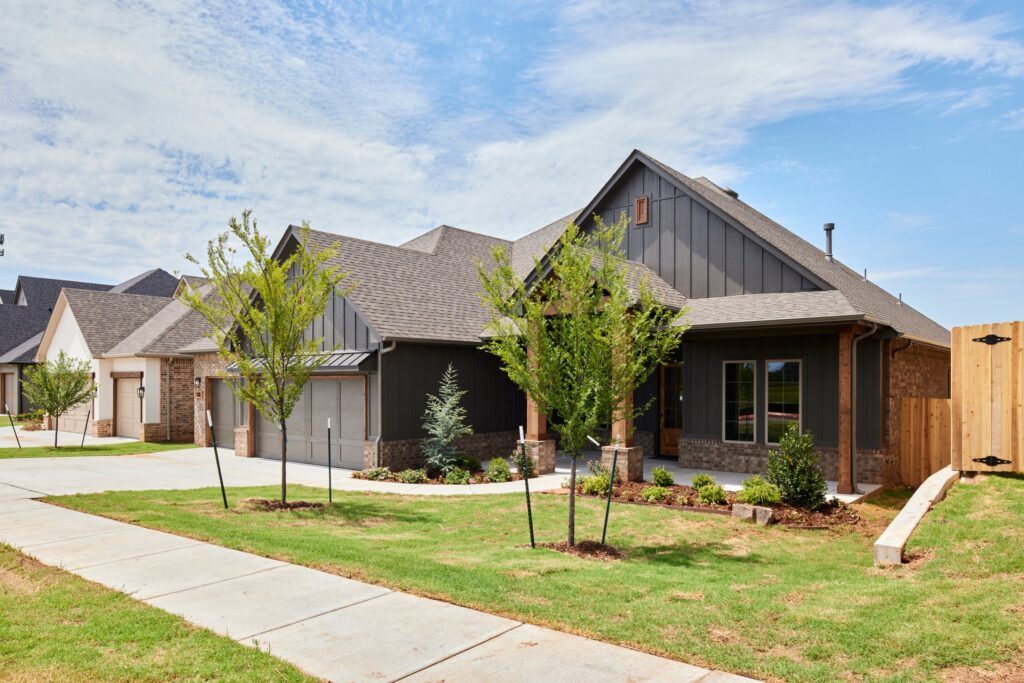 Modern dark-sided home with landscaped lawn, Teagan floor plan in the Oklahoma City metro area.