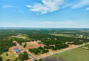 Aerial view of Prairie Estates in Oklahoma City, showcasing trees and houses in a serene rural landscape.