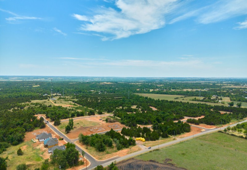 Aerial view of Prairie Estates in Oklahoma City, showcasing trees and houses in a serene rural landscape.