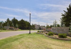 The welcoming entrance Prairie Estates community is complete with a sign and a landscaped area in Oklahoma City.