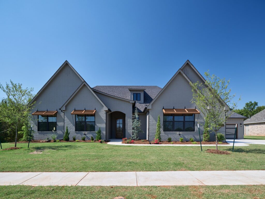 Gray brick home with gabled roof and ledger floor plan in the Oklahoma City metro area.