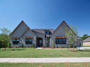 Gray brick home with gabled roof and ledger floor plan in the Oklahoma City metro area.