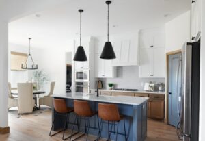 A Monochrome themed kitchen with pendant lighting.