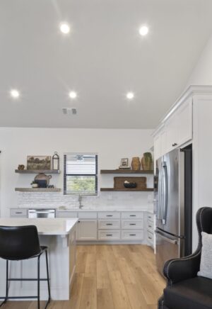 Bright kitchen in Oklahoma City with white cabinets and stylish black chairs for a contemporary look.