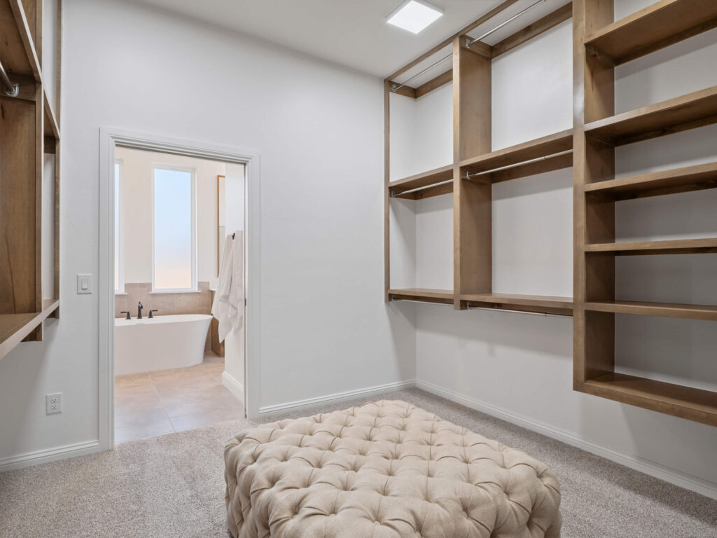 Walk in closet with wood shelving and Maddie Floor Plan in the Oklahoma City metro area