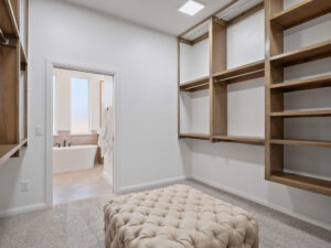 Walk in closet with wood shelving and Maddie Floor Plan in the Oklahoma City metro area