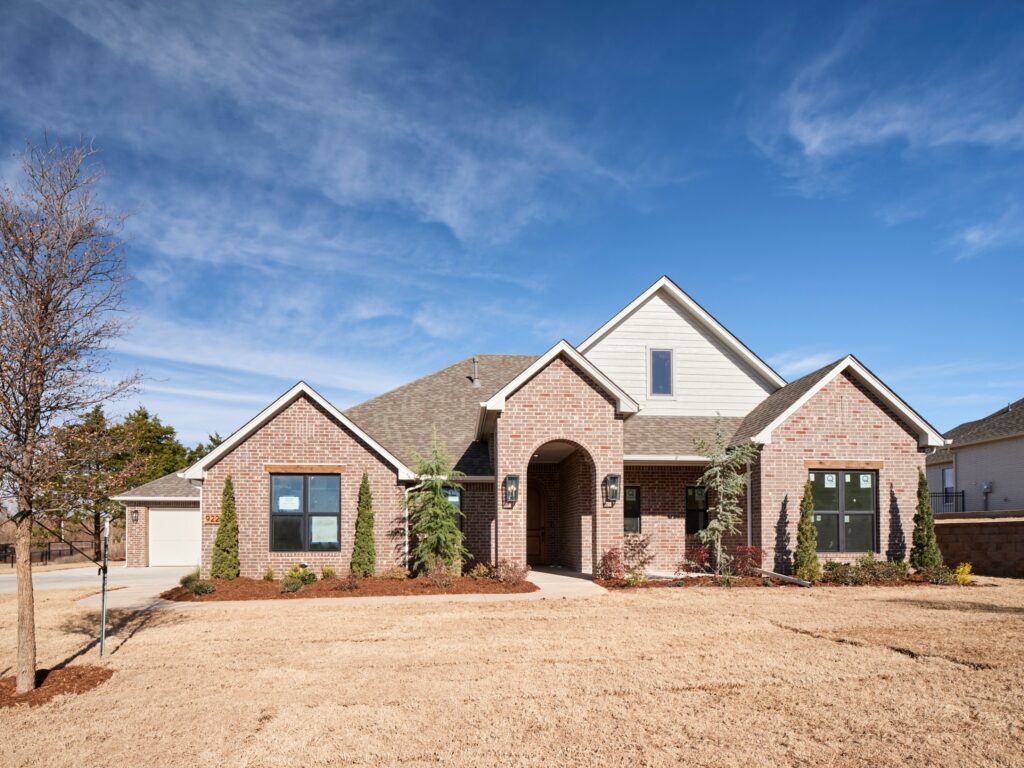 Residential brick home with a Drew floor plan and neat landscaping in the Oklahoma City metro area