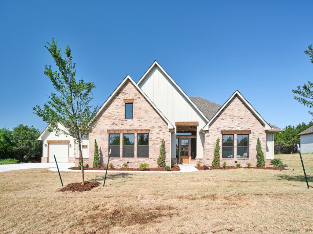 Contemporary brick house exterior and open lawn with ranger plan in the Oklahoma City metro area