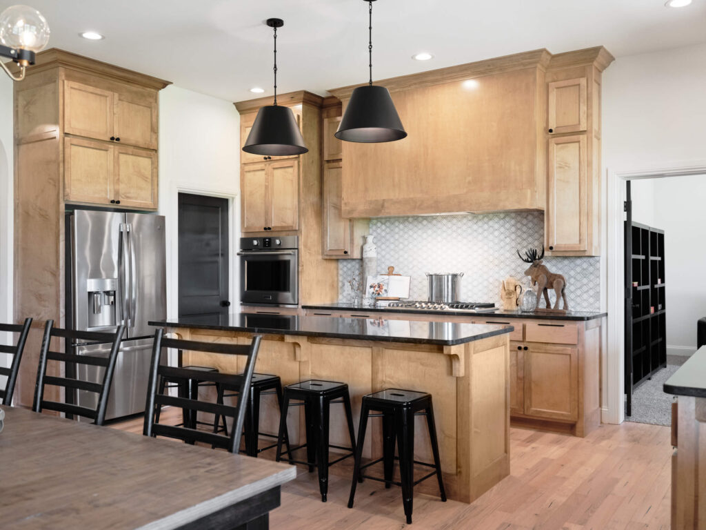 Warm wood kitchen with island seating and Hudson Floor Plan in the Oklahoma City metro area