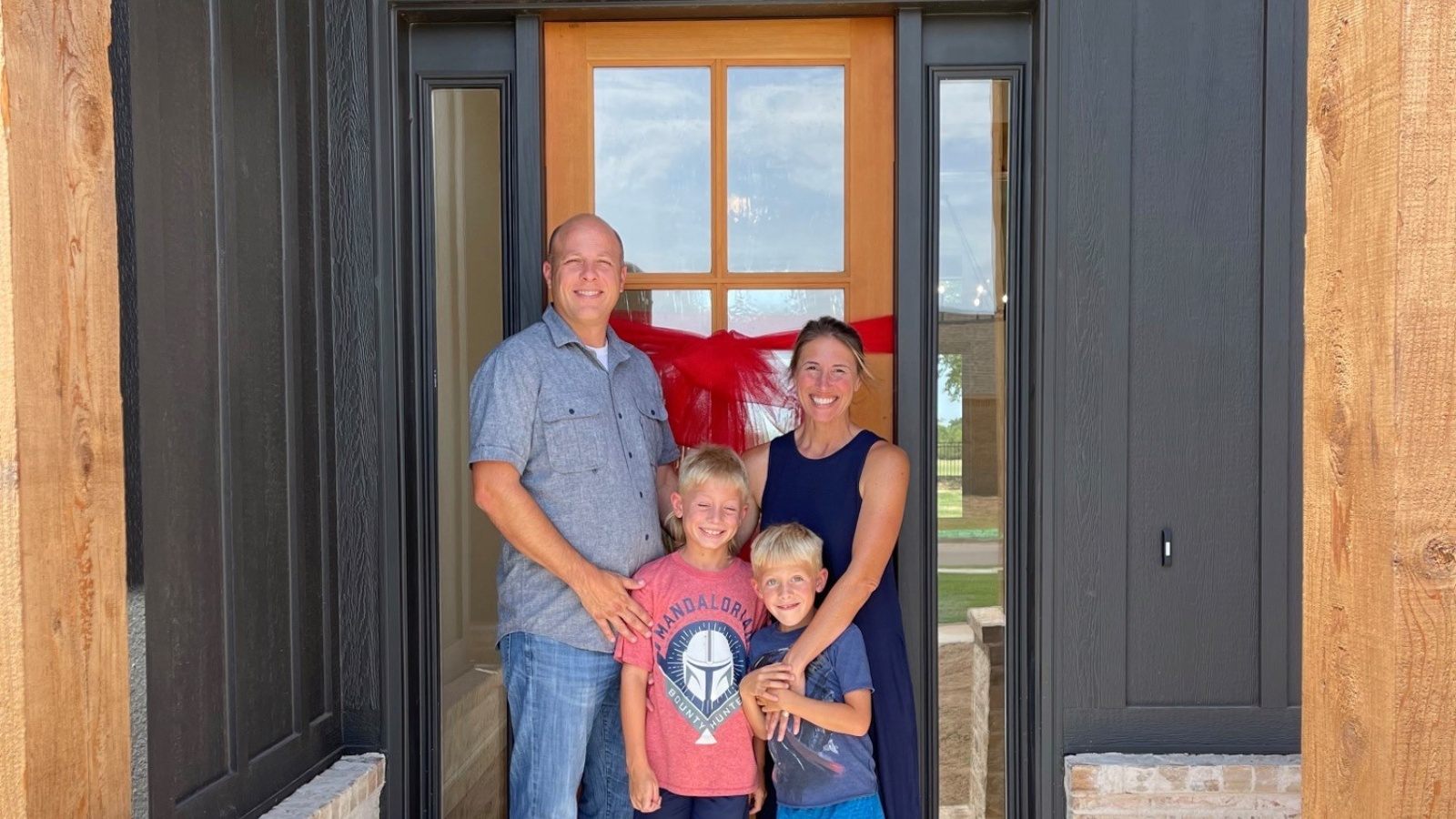 Family Standing in Front of The Home in The Oklahoma City Metropolitan Area 
