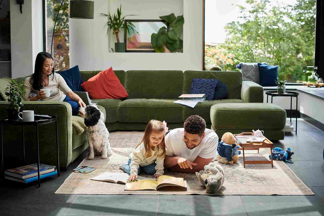 A family reading a book in a living room in OKC