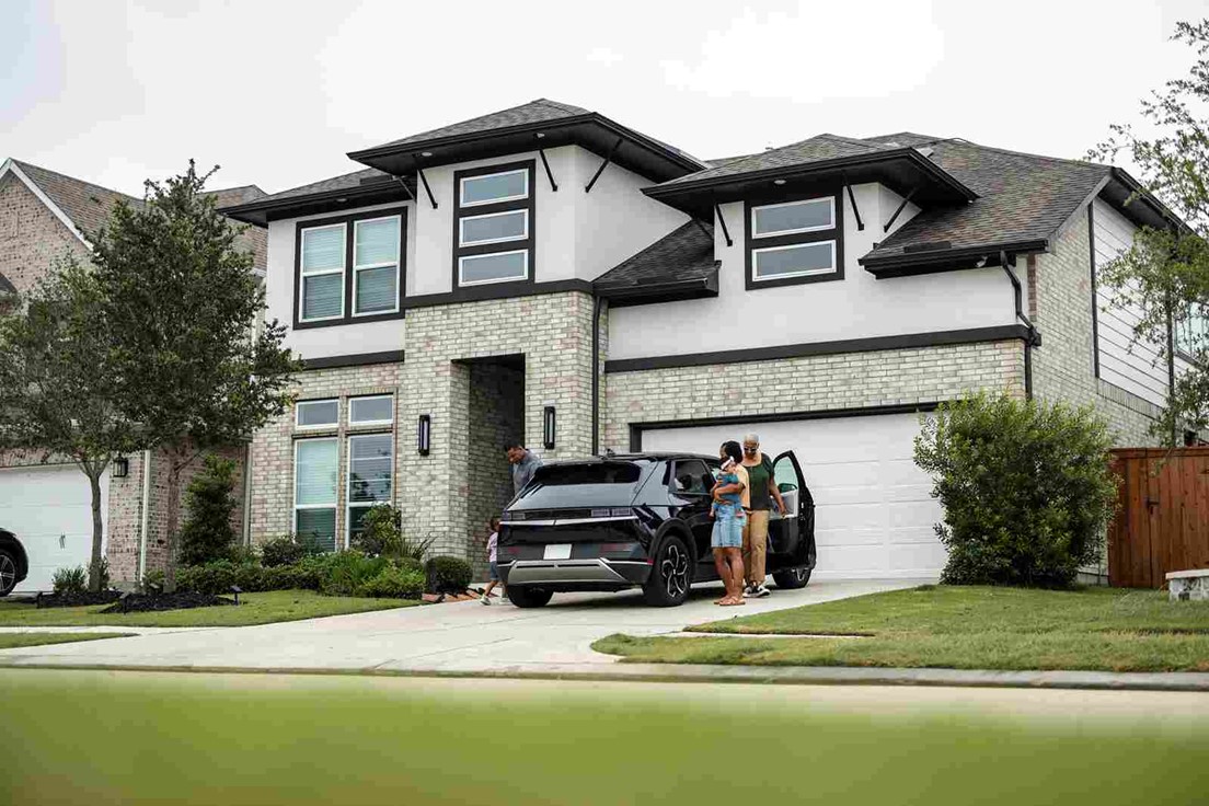 A group of people standing in front of a house in Oklahoma City Metro