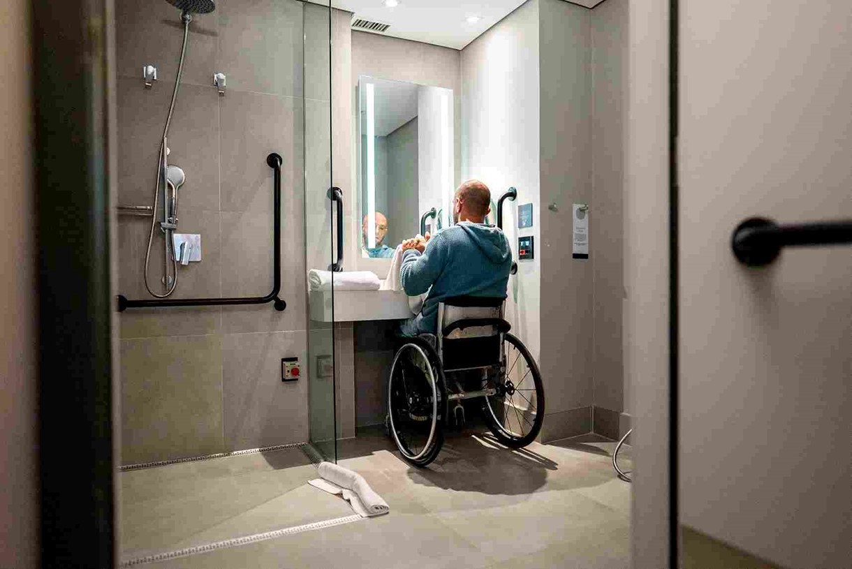 A person in a wheelchair in a bathroom in OKC