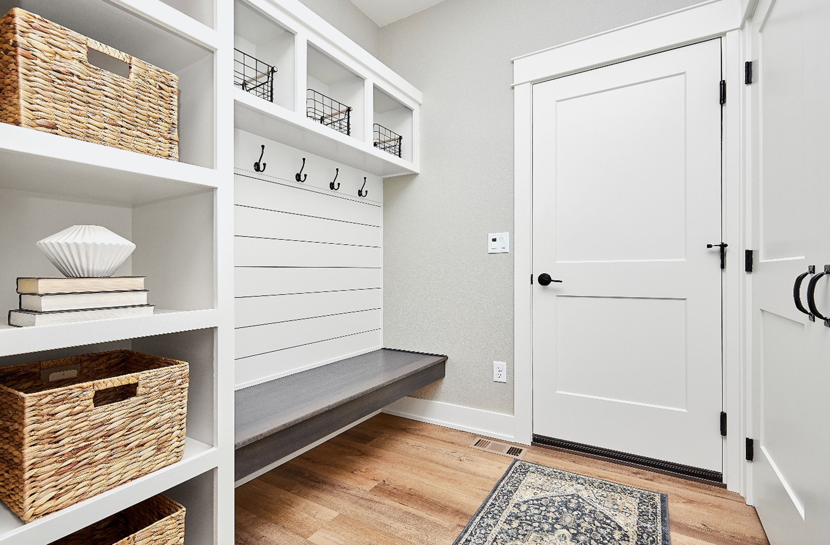 A white door with a bench and shelves in OKC