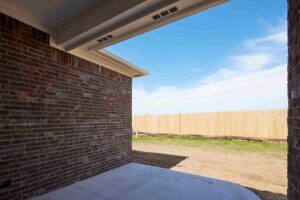 A brick wall featuring a door and a fence, located in Oklahoma City
