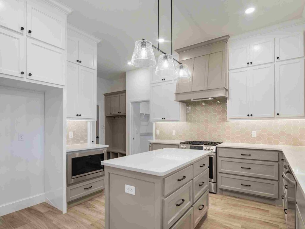 A modern kitchen in Oklahoma City featuring white cabinets and a spacious center island