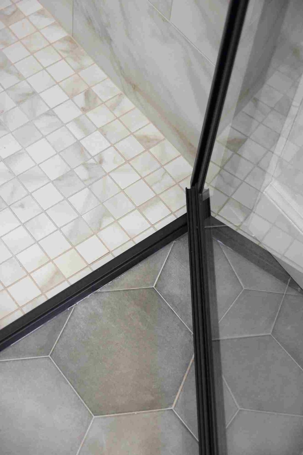 Modern shower featuring a glass door and tile flooring, situated in Oklahoma City