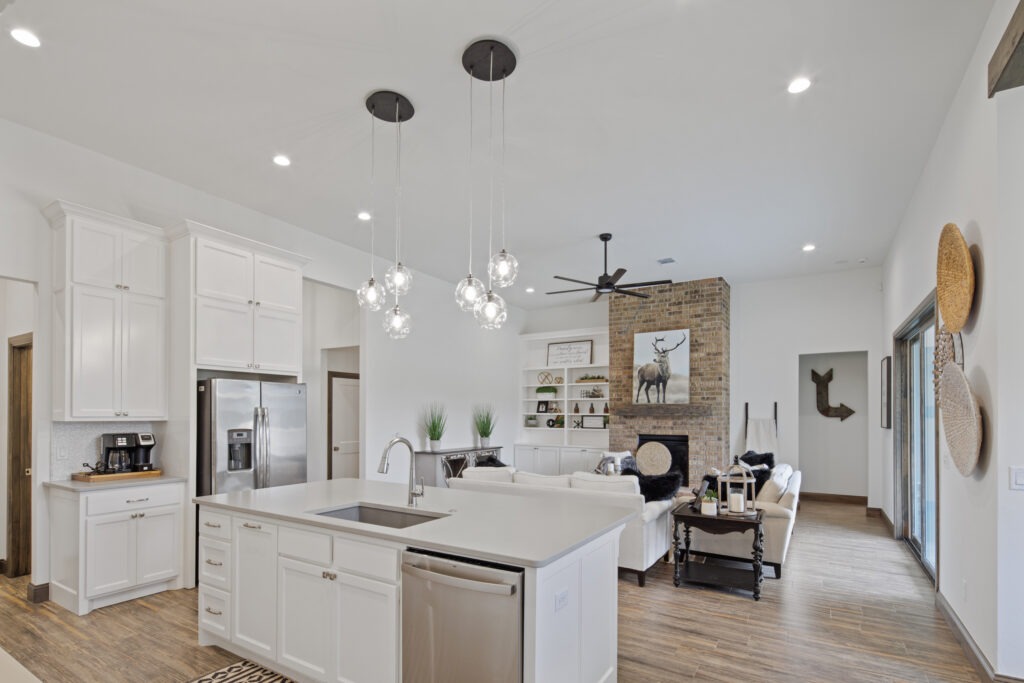Modern kitchen designs with open living space and brick fireplace in Oklahoma City