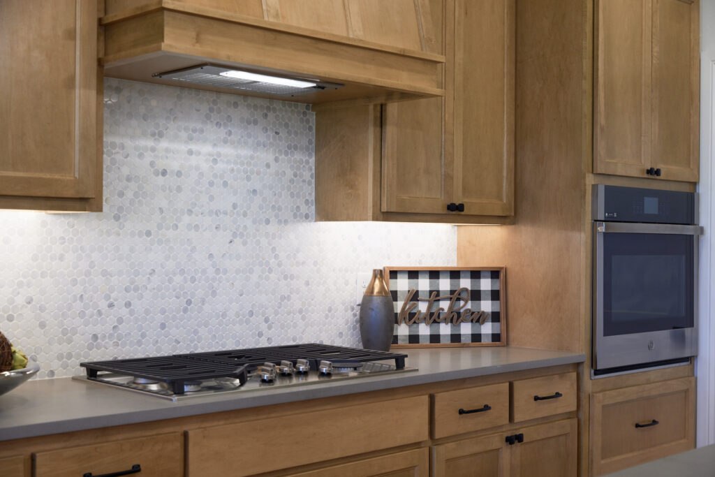 Charming kitchen with wood cabinets and modern backsplash flair in Oklahoma City