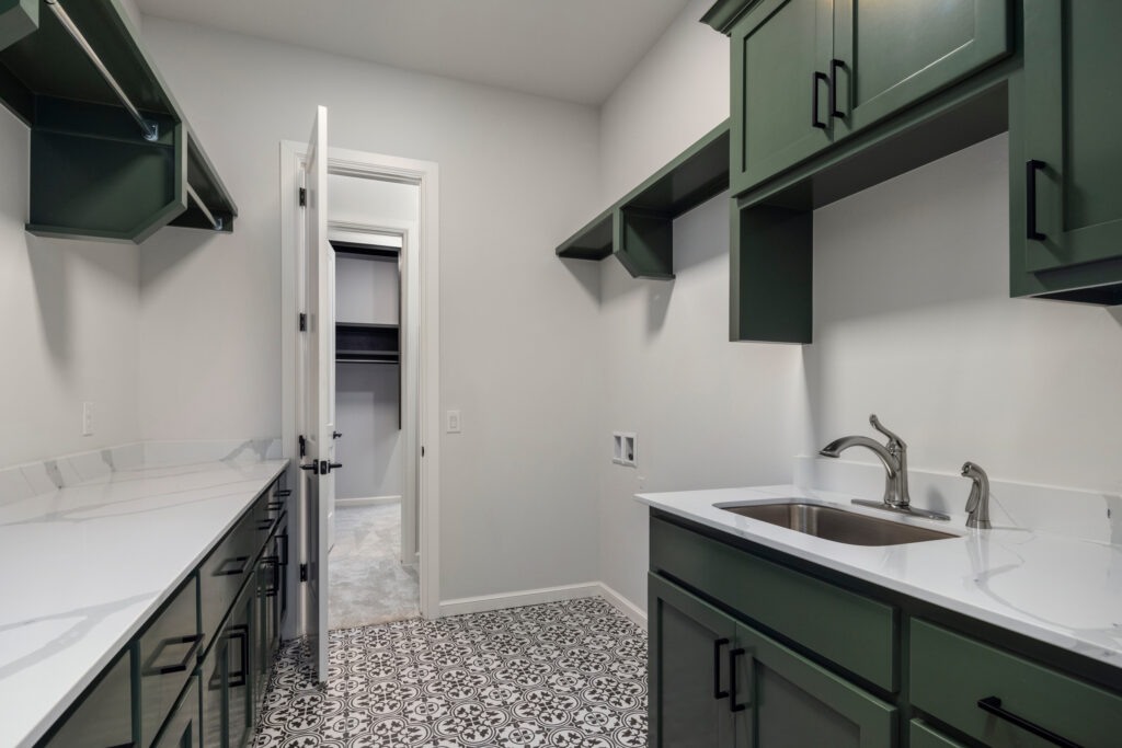 Laundry Rooms in Oklahoma City with green cabinets and patterned tile floor