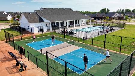 An active adult playing on the Tennis court at The Springs at Native Plains in Oklahoma City
