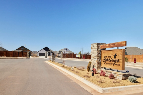 Entrance sign and homes at The Springs at Flint Hills, an active adult community in Oklahoma City