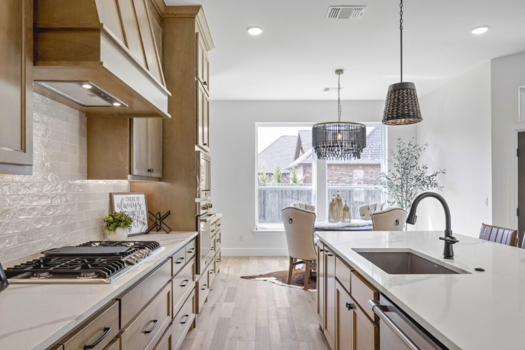 View of a kitchen with wood cabinets, countertops, and a dining area in the Oklahoma City metro area
