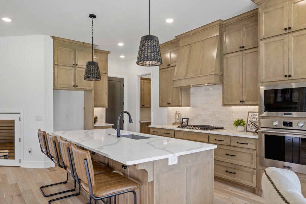 kitchen with cabinets, island seating, and black pendant lighting in the Oklahoma City metro area