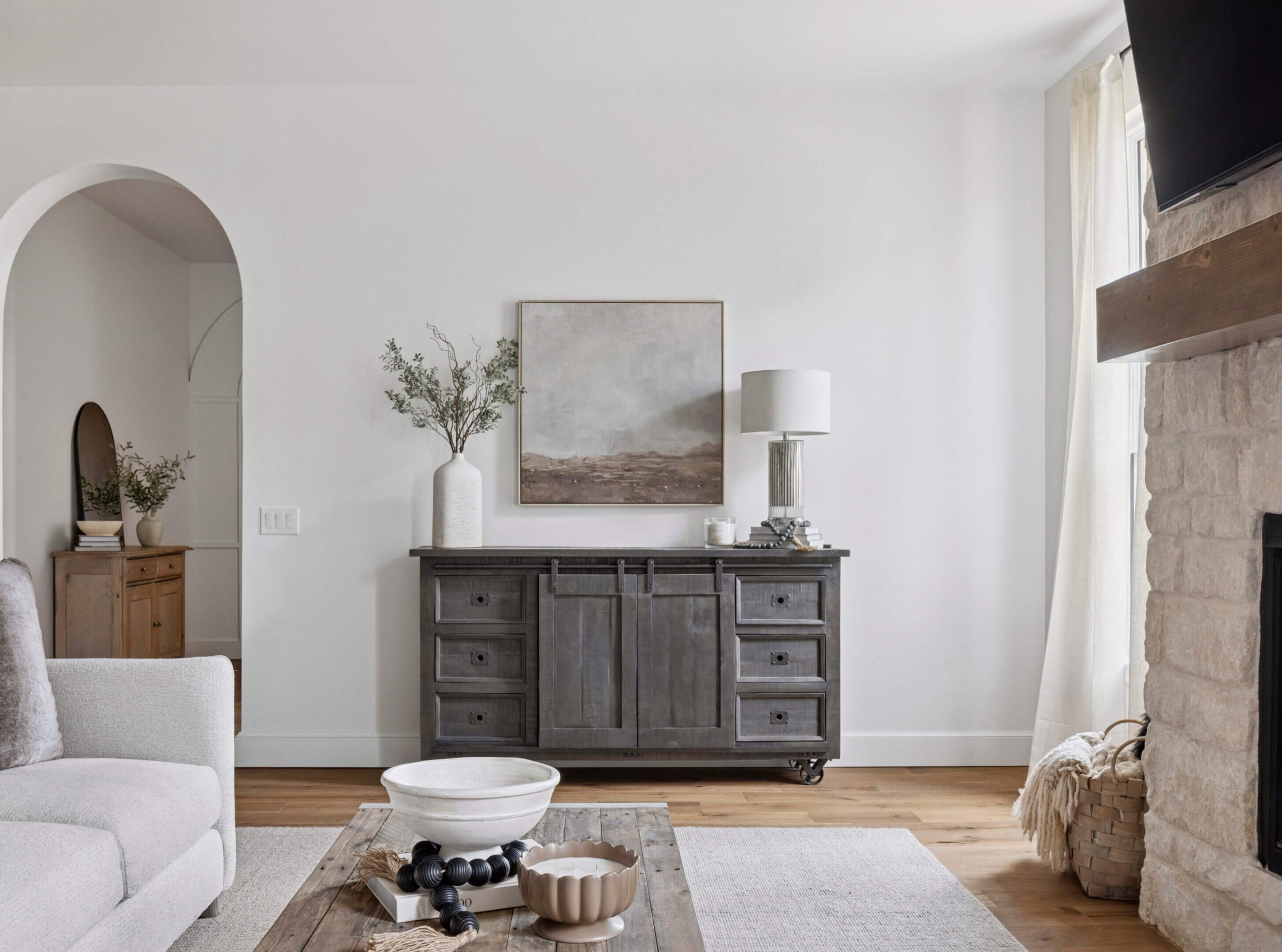 Model living room with a gray sideboard and modern neutral decor in the Oklahoma City metro area