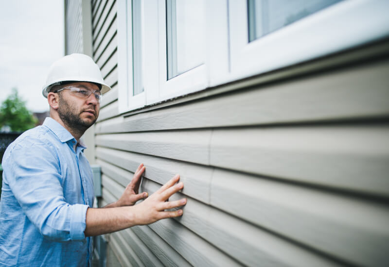 Person inspecting the quality of the constructed house in the Oklahoma City metro area