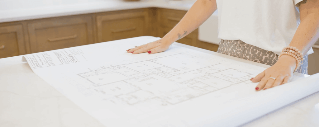 Women reviewing a large architectural blueprint in the Oklahoma City metro area
