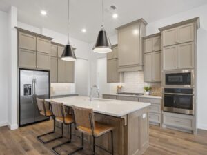 Modern kitchen with island, pendant lighting, and cabinetry in Oklahoma City metro area home