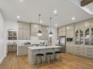 Spacious kitchen with large island, pendant lights, and cabinetry in Oklahoma City metro area home