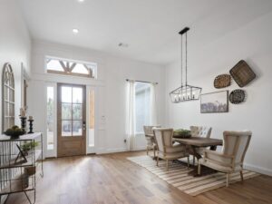 Bright dining room with wood table, upholstered chairs, and chandelier in Oklahoma City metro area
