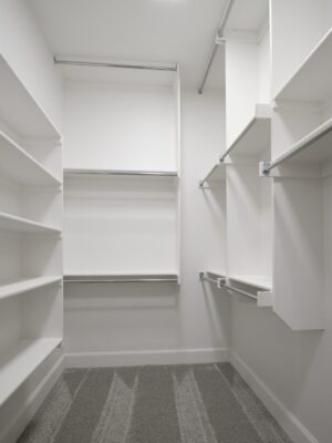 Walk-in closet with built-in shelving and hanging rods in Oklahoma City metro area home
