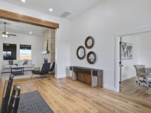 Open living area with wood floors, accent wall, and adjacent office in Oklahoma City metro area