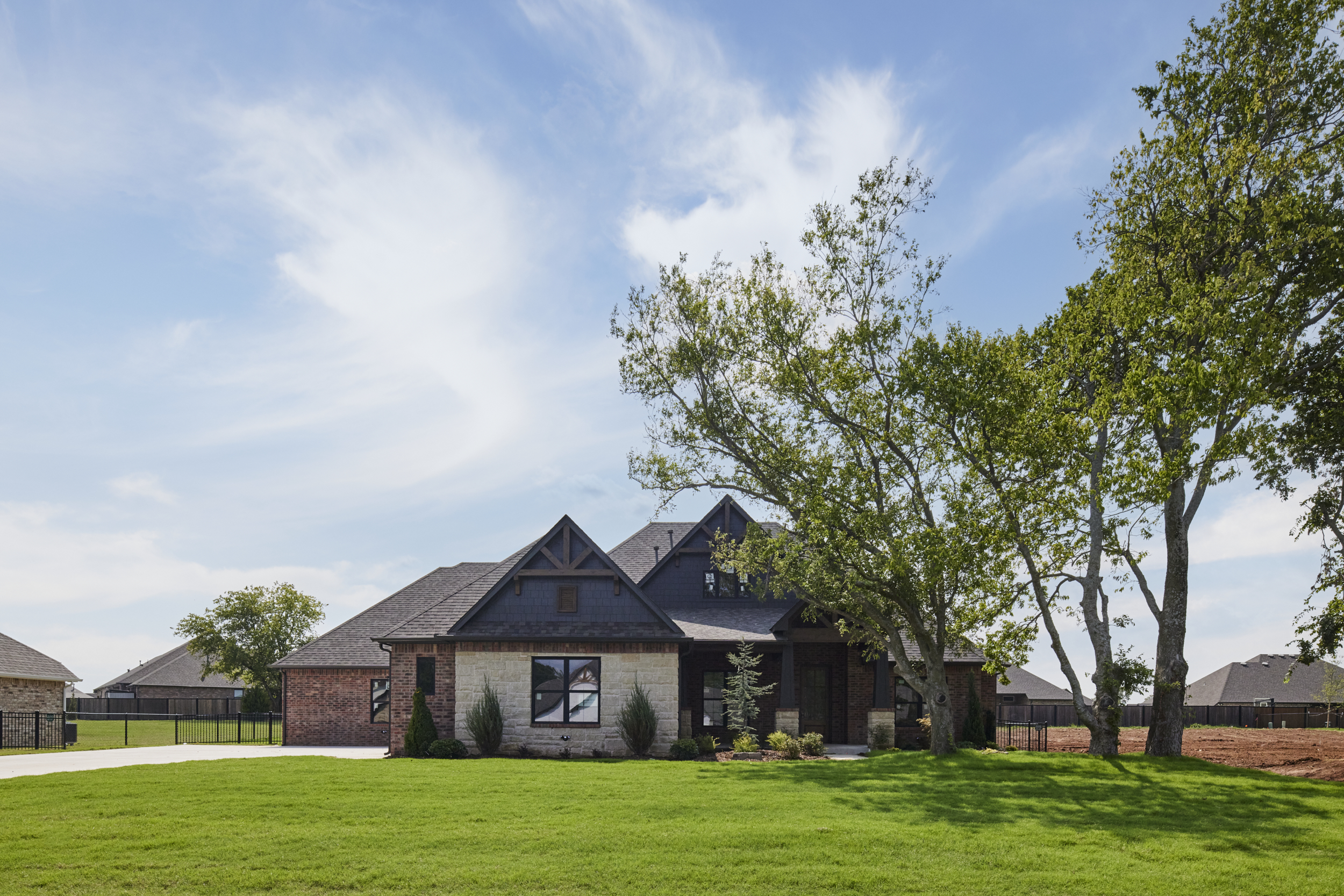 Custom home built on a spacious homesite with a large green lawn