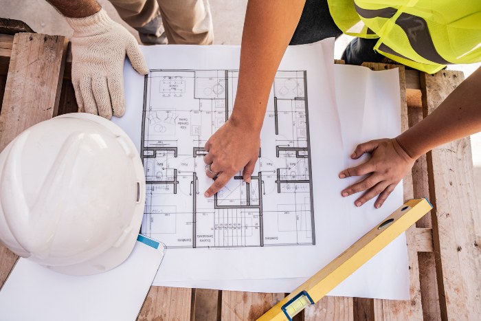 Custom home builder reviewing construction plans for a new residential project in Oklahoma