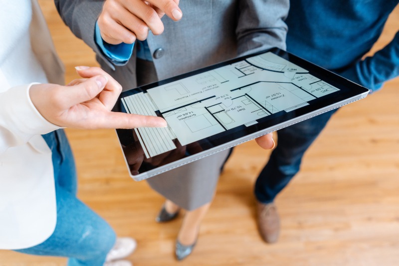 Real estate agent reviewing a custom home floor plan