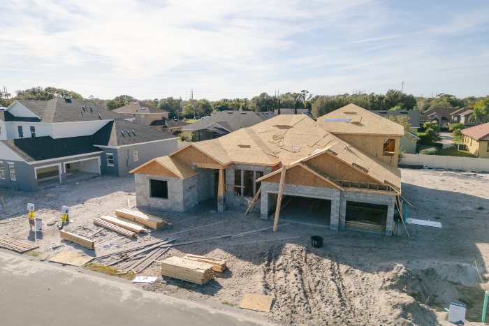New construction home in progress with roof framing